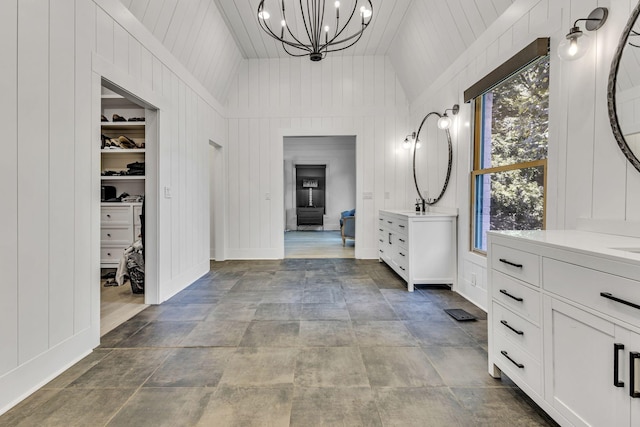 hallway featuring a notable chandelier, lofted ceiling, and wooden ceiling