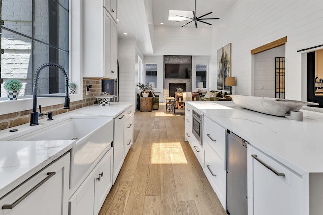 kitchen featuring white cabinetry and light stone counters