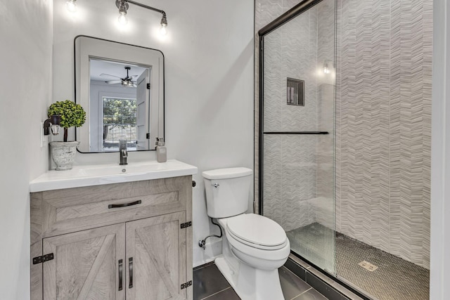 bathroom featuring vanity, toilet, and a tile shower