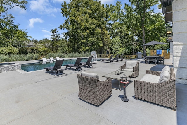 view of patio / terrace with a pool with hot tub and an outdoor hangout area