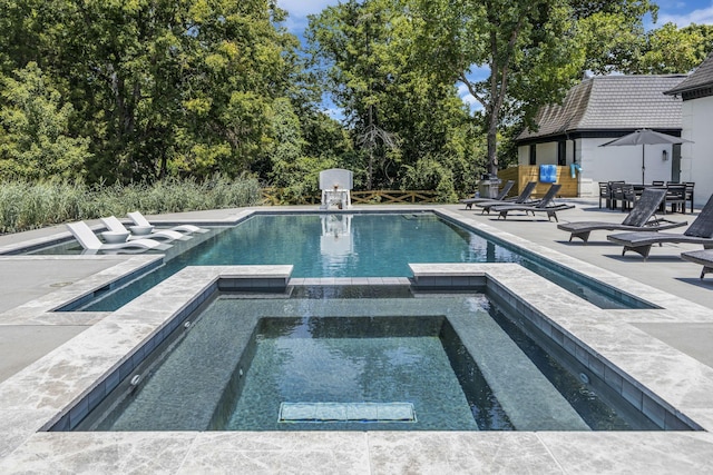 view of pool with an in ground hot tub and a patio