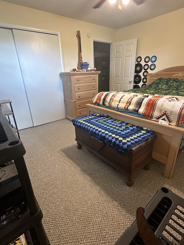 carpeted bedroom featuring ceiling fan and a closet