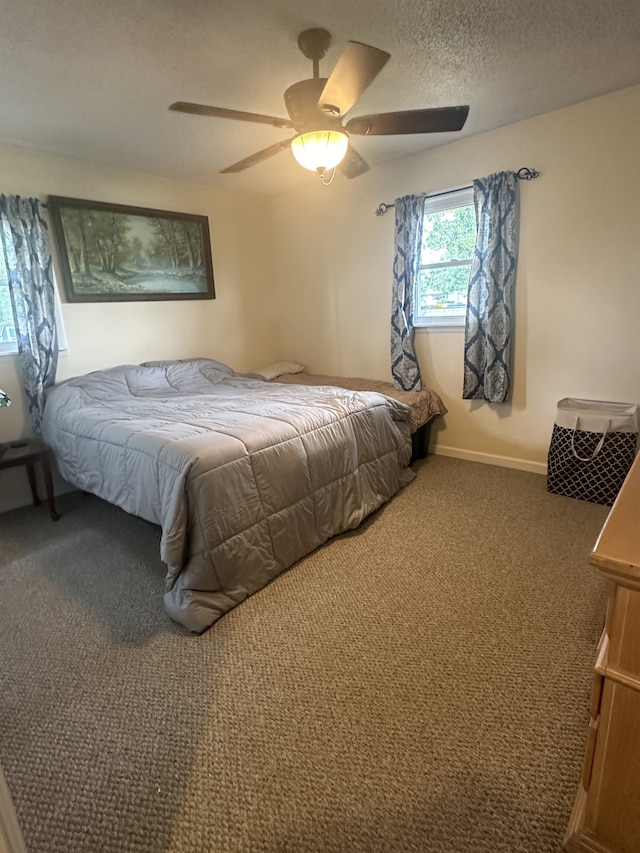 bedroom with a textured ceiling, carpet, and ceiling fan