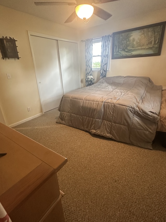 carpeted bedroom with a closet and ceiling fan