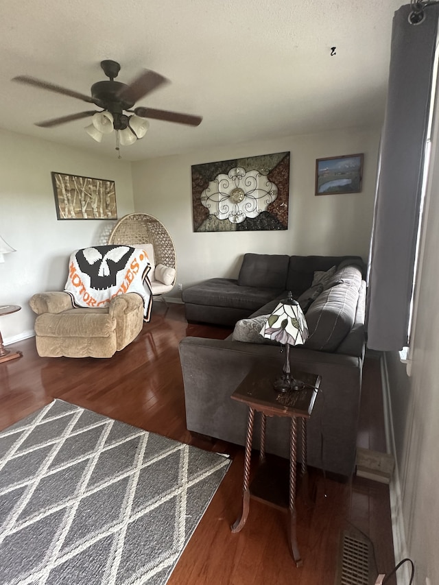 living room with ceiling fan and wood-type flooring