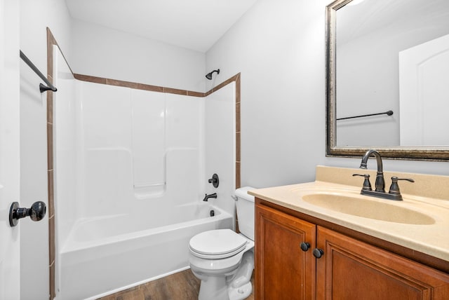 full bathroom featuring toilet, hardwood / wood-style floors, vanity, and washtub / shower combination