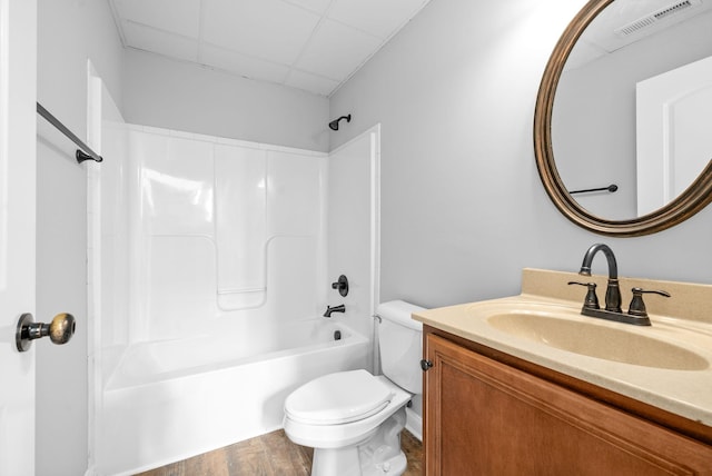 full bathroom featuring toilet, bathing tub / shower combination, hardwood / wood-style flooring, and vanity