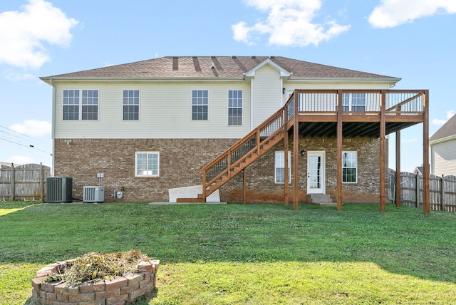 back of property featuring a deck, a lawn, and central air condition unit