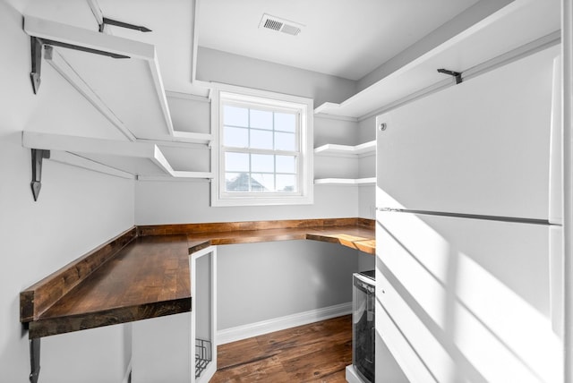 walk in closet with dark wood-type flooring