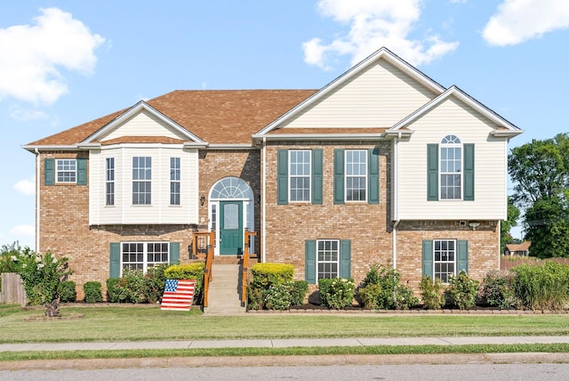 raised ranch featuring a front lawn