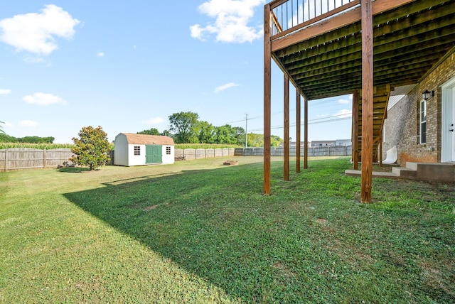 view of yard featuring a deck and a storage shed