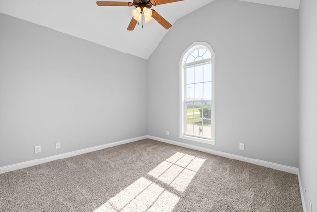 empty room with carpet floors, vaulted ceiling, and a healthy amount of sunlight