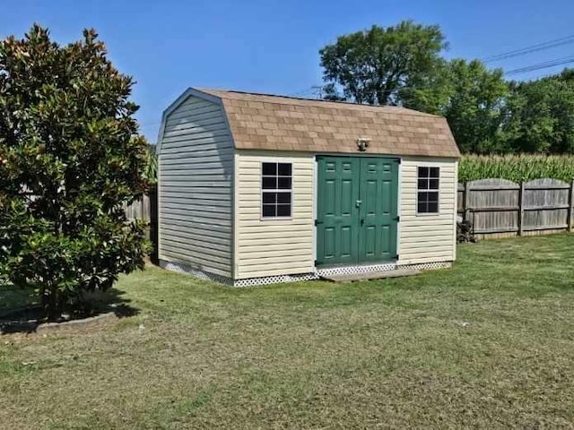 view of outbuilding featuring a yard