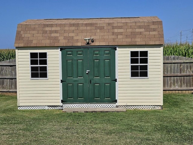 view of outbuilding with a lawn