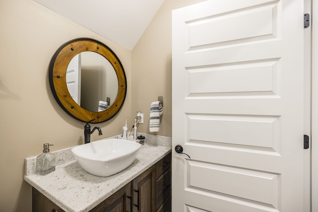 bathroom featuring vanity and vaulted ceiling