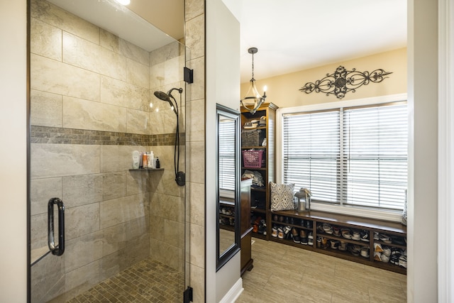 bathroom with a shower with door and tile patterned flooring