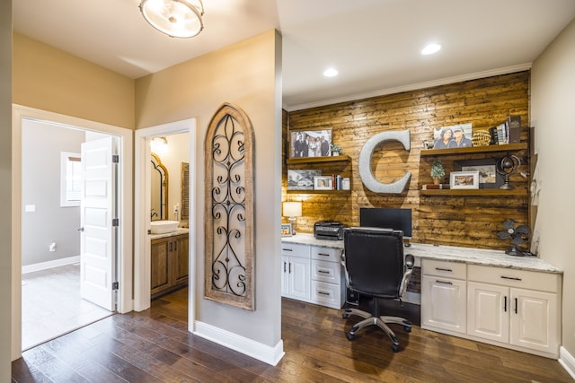 office featuring built in desk, wooden walls, and dark wood-type flooring