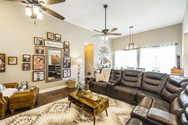 living room with dark wood-type flooring and ceiling fan