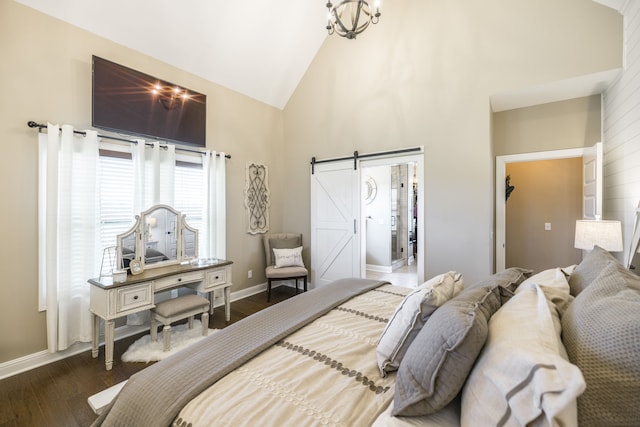 bedroom with dark hardwood / wood-style flooring, a barn door, and high vaulted ceiling