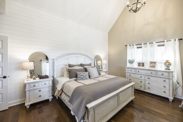 bedroom with dark hardwood / wood-style floors, a chandelier, and high vaulted ceiling