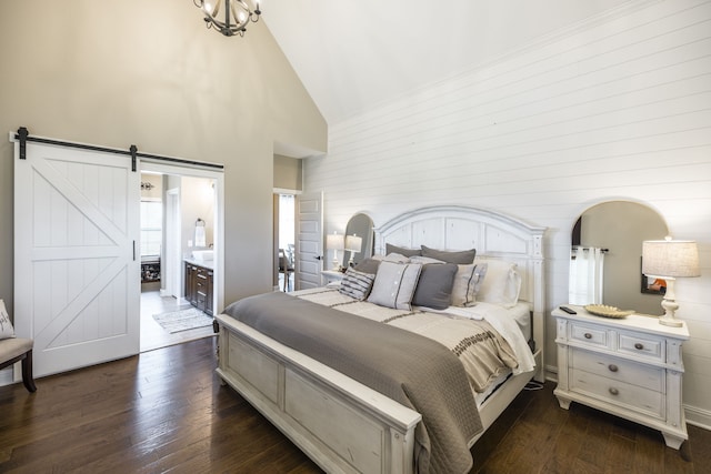 bedroom with high vaulted ceiling, ensuite bathroom, dark hardwood / wood-style flooring, and a barn door