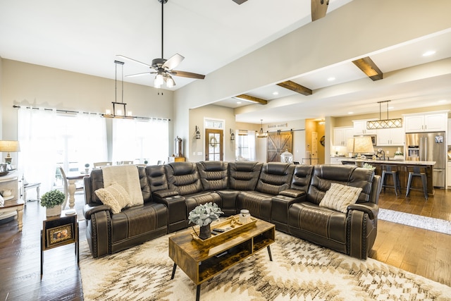 living room featuring beam ceiling, hardwood / wood-style flooring, and ceiling fan