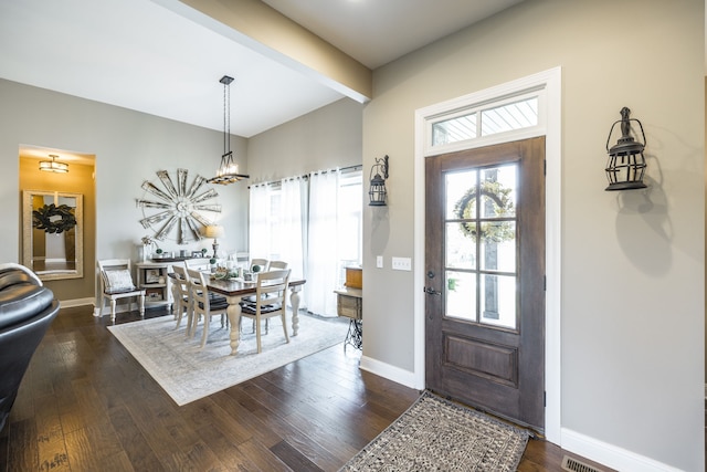 entryway featuring dark hardwood / wood-style flooring and beam ceiling