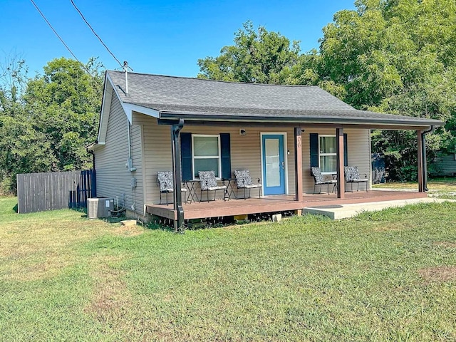 view of front of home with a porch, cooling unit, and a front lawn