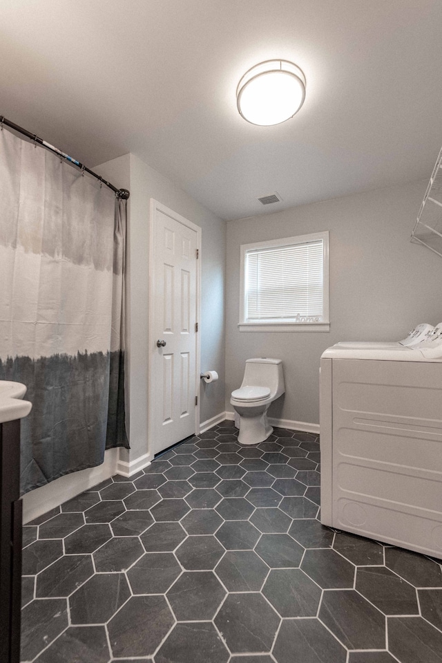 bathroom with curtained shower and toilet