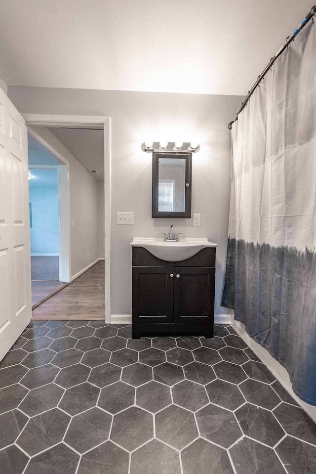 bathroom featuring hardwood / wood-style floors, curtained shower, and vanity