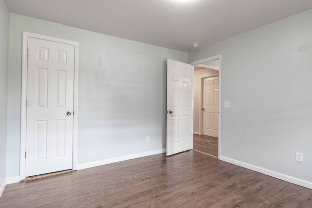 empty room featuring dark wood-type flooring