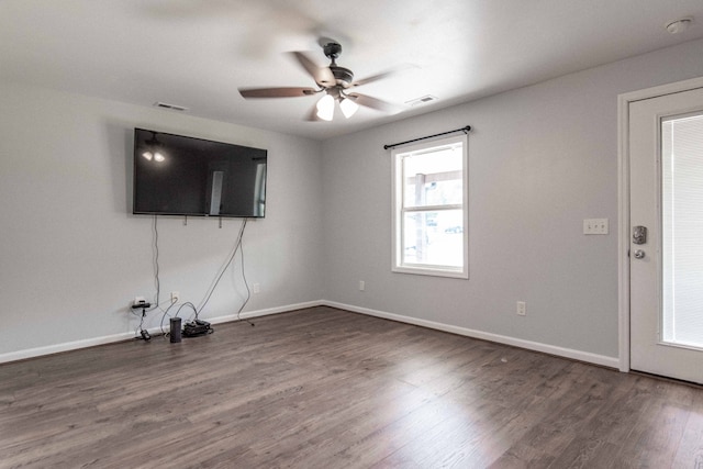 unfurnished living room with dark wood-type flooring and ceiling fan