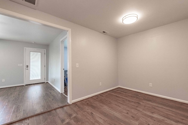 empty room with dark wood-type flooring