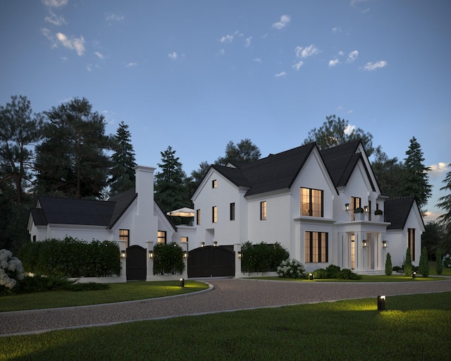 modern inspired farmhouse featuring driveway, a chimney, a front yard, and a gate