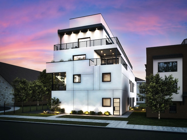 exterior space with stucco siding and a balcony