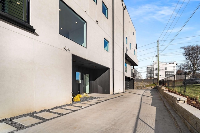 view of building exterior with fence