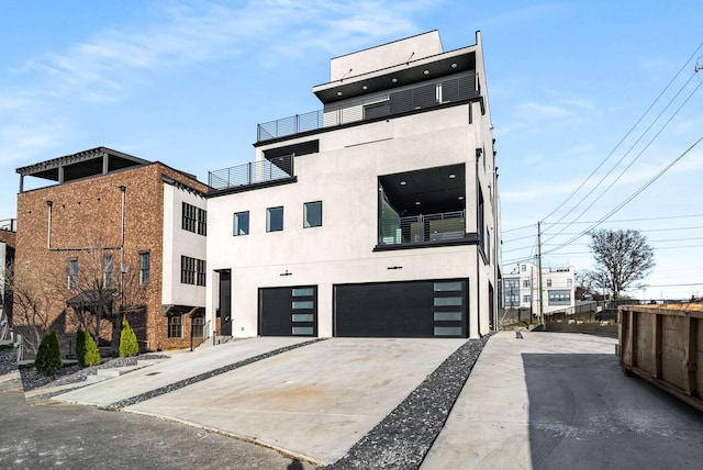 modern home featuring stucco siding, concrete driveway, and an attached garage