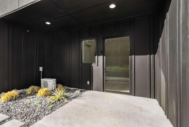 property entrance featuring ac unit and a patio area