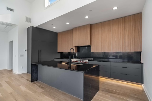 kitchen featuring dark countertops, visible vents, and modern cabinets