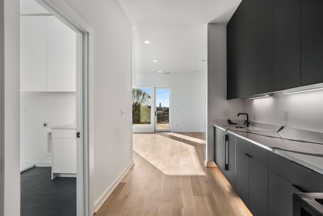 interior space featuring light wood-style flooring, modern cabinets, and light countertops