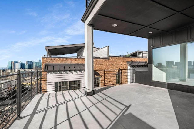 view of patio featuring a balcony and a city view