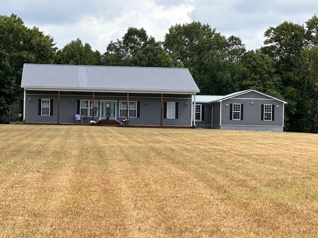 ranch-style home featuring covered porch and a front lawn