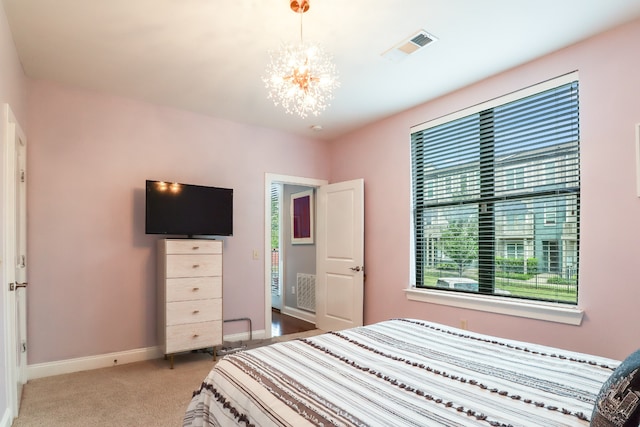 carpeted bedroom with a chandelier