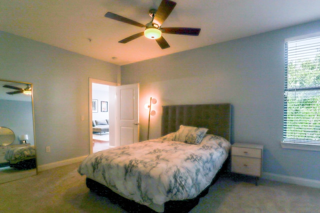 bedroom with multiple windows, carpet floors, and ceiling fan