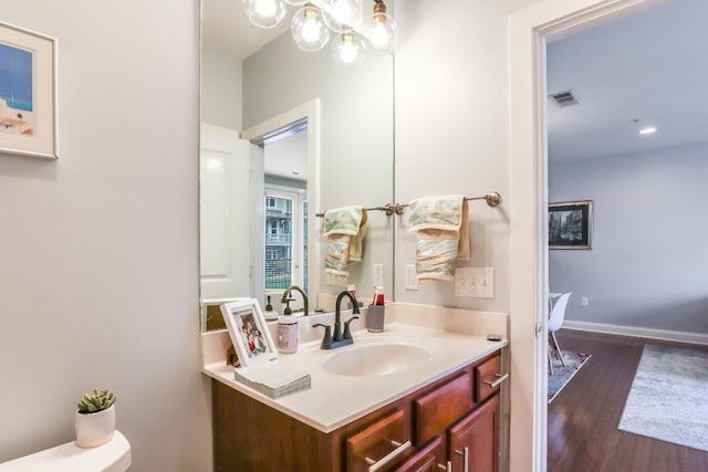 bathroom featuring vanity, hardwood / wood-style floors, and toilet