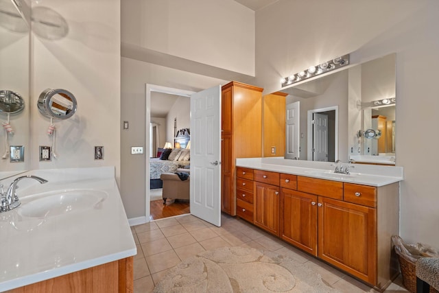 bathroom featuring vanity, tile patterned floors, and a high ceiling