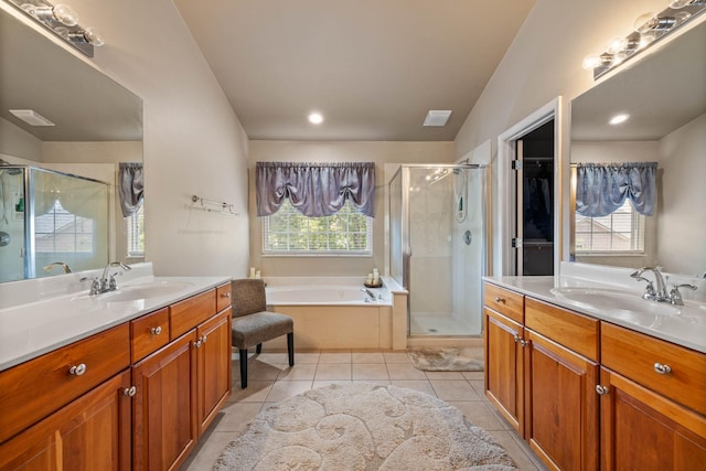 bathroom with tile patterned flooring, vanity, and plus walk in shower