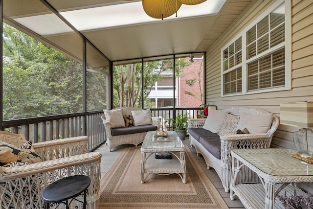 sunroom / solarium featuring ceiling fan