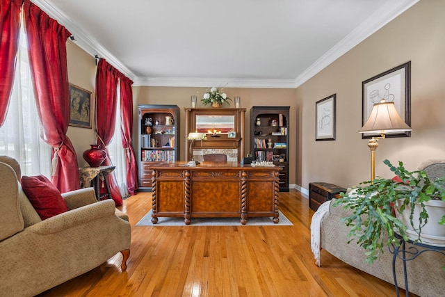 home office with crown molding and light hardwood / wood-style flooring