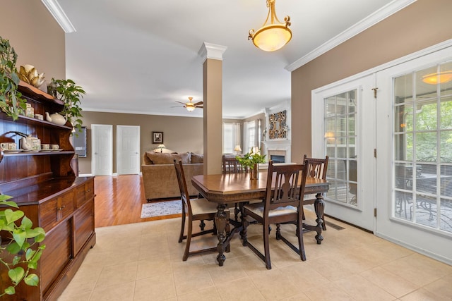 dining area with ornate columns, ornamental molding, plenty of natural light, and ceiling fan